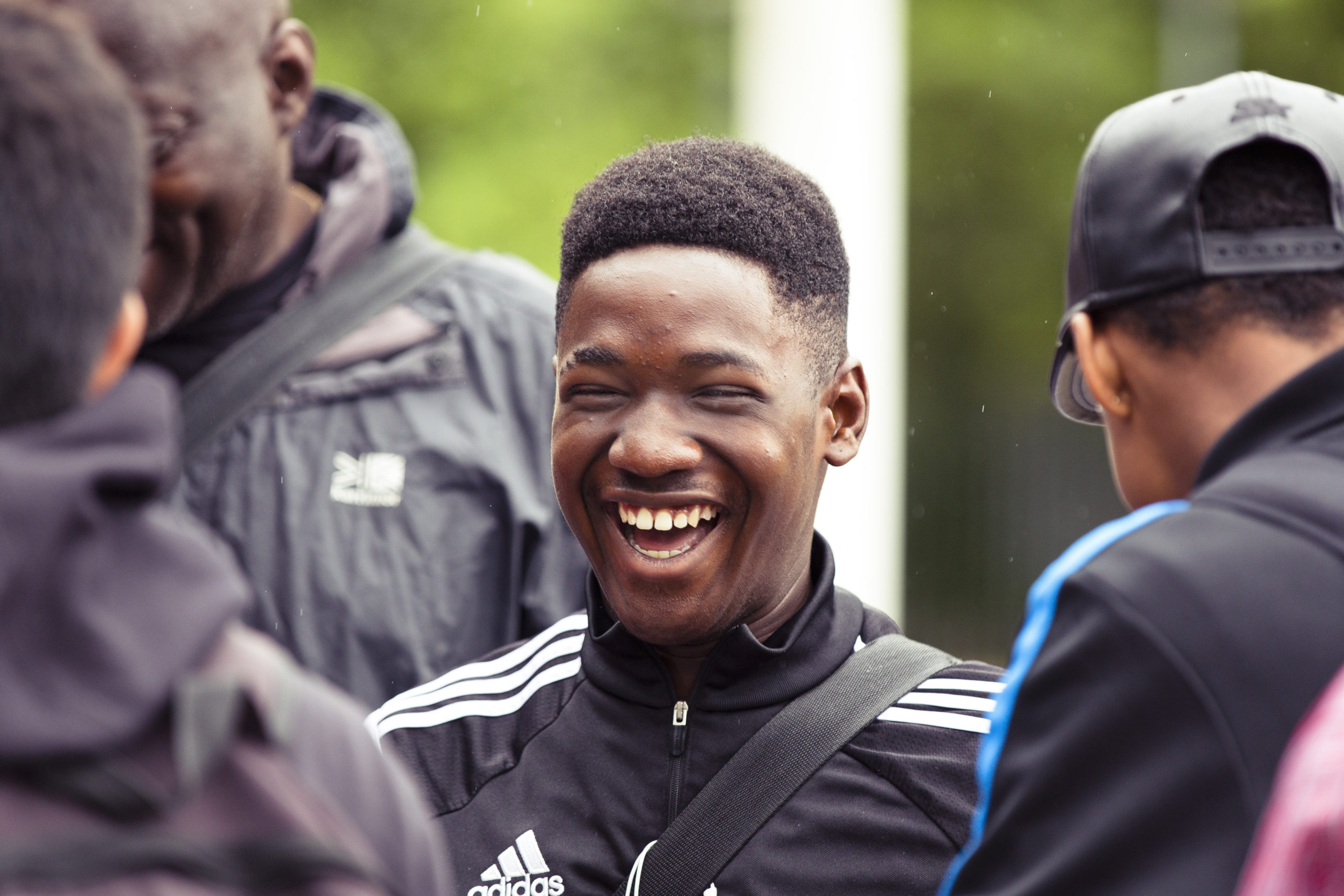 Happy young man in adidas jacket